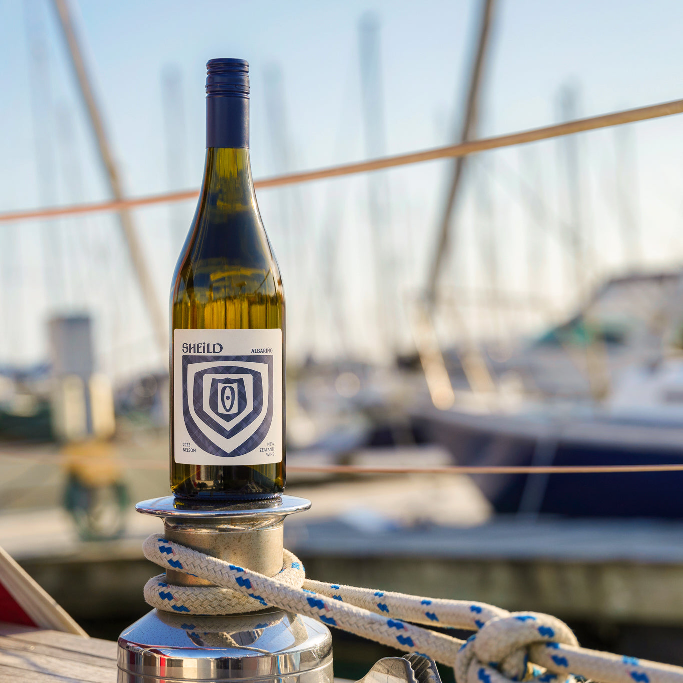 SHEiLD's Albariño wine placed on a marina mooring on a sunny day.